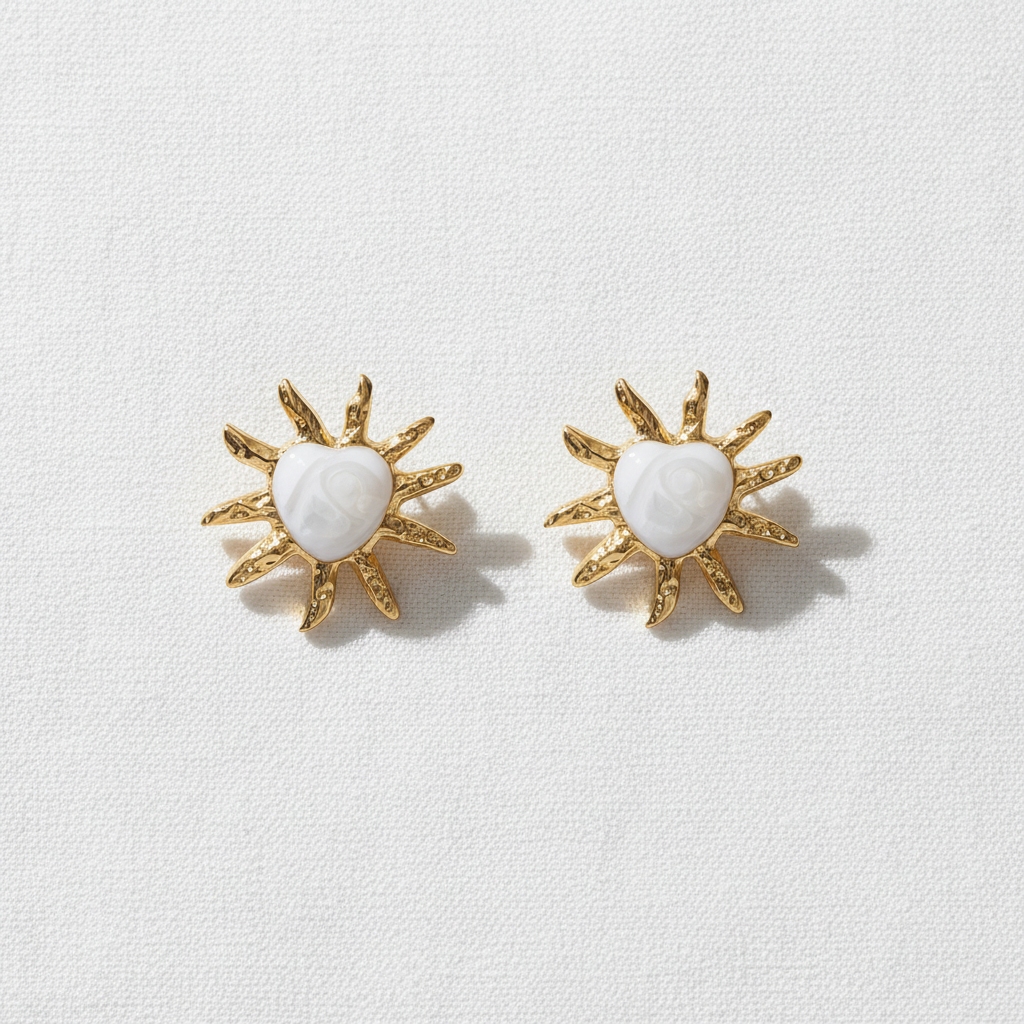 Radiant Sol Heart Earrings on white linen
