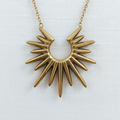 Sunburst pendant close-up on white linen